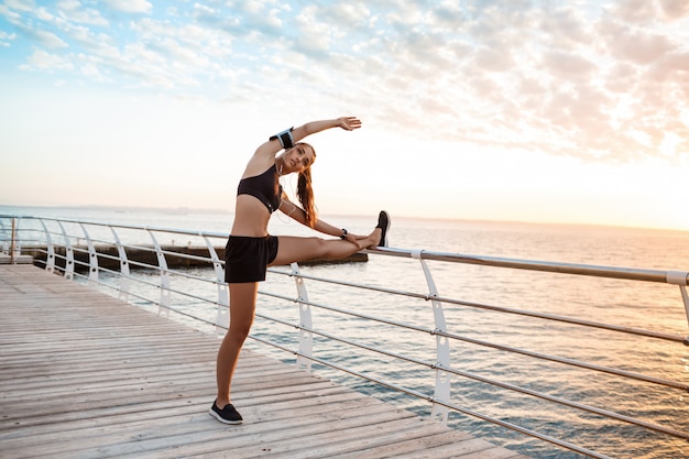 Young Beautiful Sportive Girl Training at Sunrise Over Seaside – Free Download