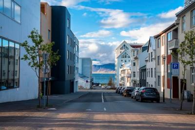 Cars Parked on Road In Front of Buildings by the Sea – Free Download