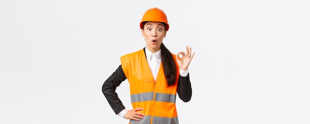 Asian Female Construction Manager Expressing Excitement with Safety Gear – Free Download