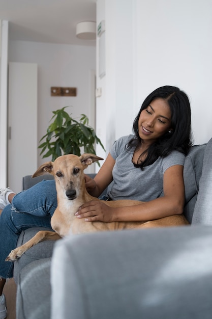 Smiling Woman and Dog Relaxing on Couch – Free Stock Photo for Download