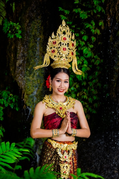 A Woman in an Ancient Thai Dress at a Waterfall – Free Download