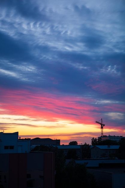 A Construction Crane Silhouetted Against a Breathtaking Sunset with Vibrant Pink and Blue Hues – Free Download