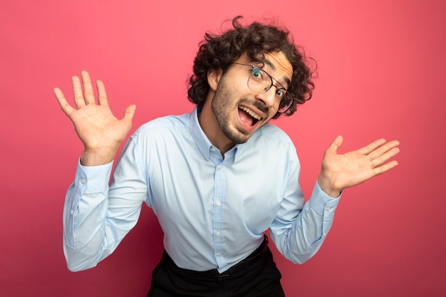 Handsome Young Caucasian Man in Glasses Posing with Empty Hands on Crimson Background – Free Download