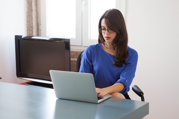 Busy Secretary Working on Laptop – Free Stock Photo for Download