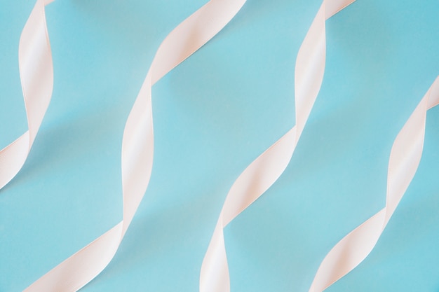 Peach Satin Ribbon Decoration on Blue Background – Free Download