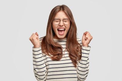 Pleased Young Woman Celebrating Success – Free Download