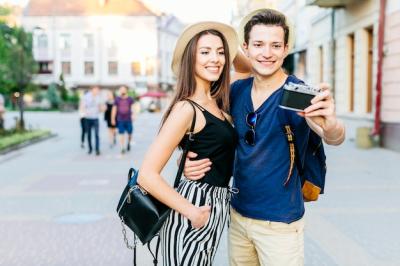 Tourist Couple Posing for Photo in City – Free Download