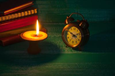 Still Life Candlestick and Alarm Clock on Old Book – Free Stock Photo for Download