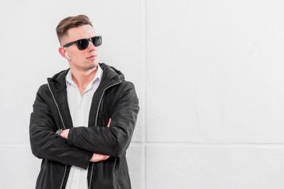 Confident Young Man with Sunglasses and Wireless Earphones – Free Stock Photo for Download