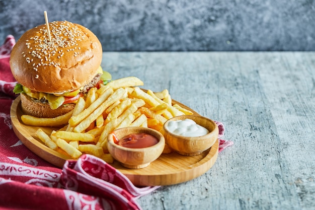 A Wooden Plate Full of Burger and Fries with Ketchup and Mayonnaise – Free Stock Photo, Download Free