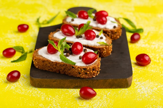 Delicious Bread Toasts with Sour Cream and Dogwoods on Yellow – Free Stock Photo for Download