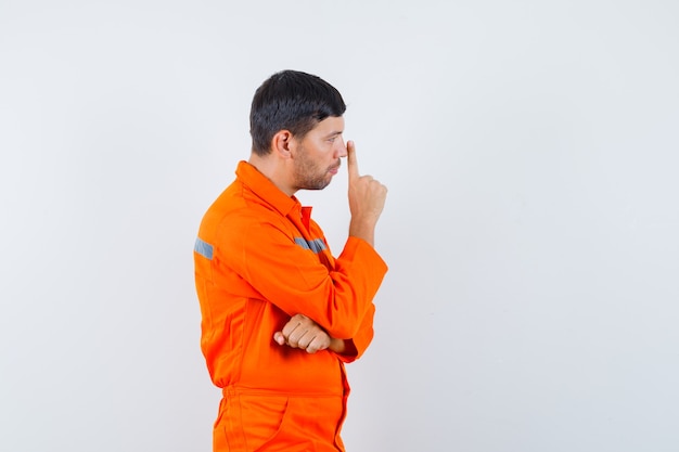 Young Worker in Uniform Looking Pensive – Free Stock Photo for Download