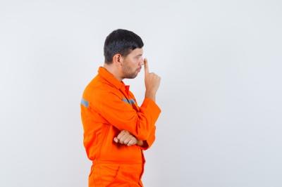 Young Worker in Uniform Looking Pensive – Free Stock Photo for Download