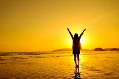 Relaxed Woman Jumping in the Sea on the Beach – Free Download