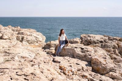 Stunning Extra Long Shot of a Woman Sitting on Rocks – Free Download