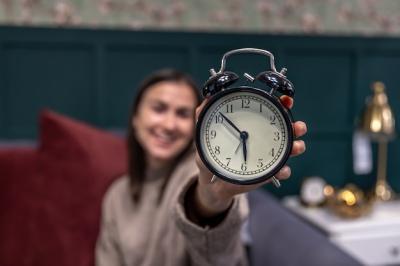 Black Vintage Retro Alarm Clock in Female Hands – Free Download