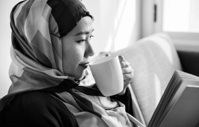 Islamic Woman Enjoying Coffee While Reading – Free Download