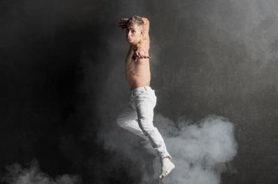 Male Performer Posing in Mid-Air with Smoke – Free Download