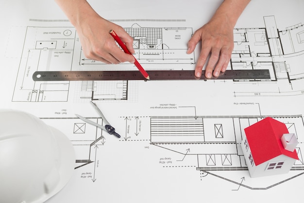 Close-up of a Human Hand Drawing a Line on a Blueprint – Free Download