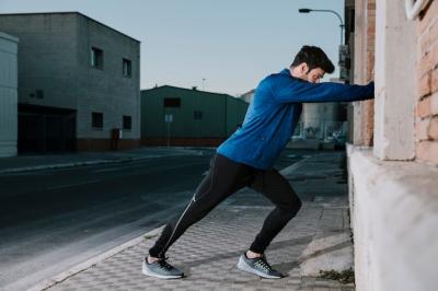 Dynamic Man Stretching on Pavement – Free Stock Photo for Download