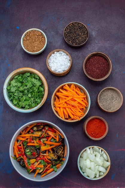 Distant View of Greens, Seasonings, and Sliced Onions on Dark Desk – Free to Download