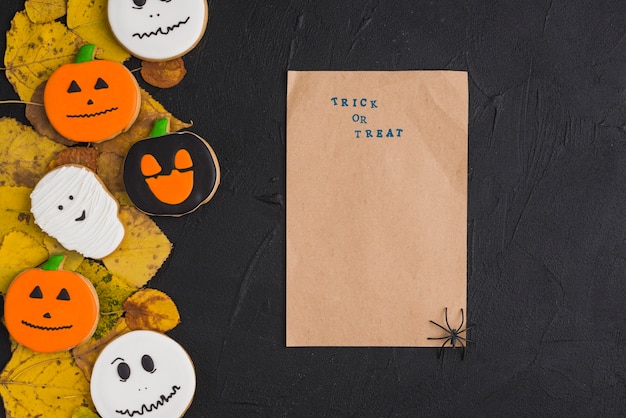 Halloween Inspired Craft Paper with Spider Near Cookies and Leaves – Free Download