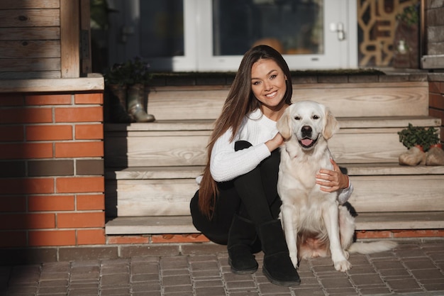 Young Woman Enjoying Time Outdoors with Retriever Dog – Free Download