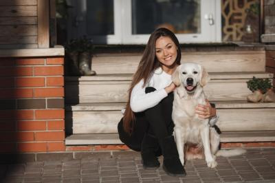 Young Woman Enjoying Time Outdoors with Retriever Dog – Free Download