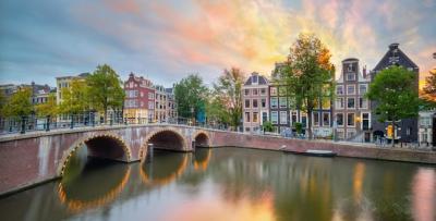 Romantic Sunset Views of Amsterdam’s Bridges and Canals – Free Download