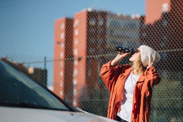 Woman Enjoying Coffee Near Car – Free Download