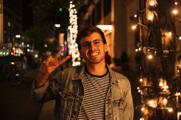 Man Making Peace Sign and Smiling – Free Download