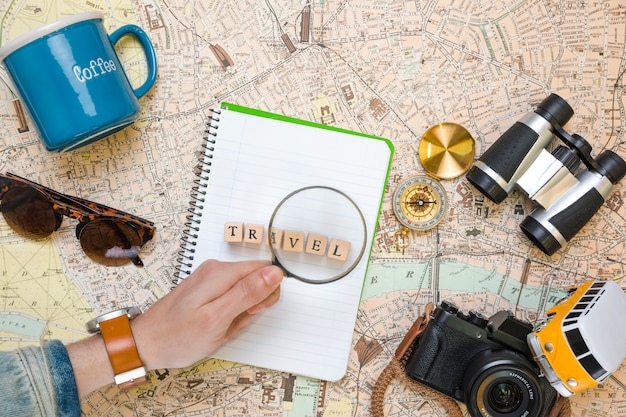 Magnifying Glass on Wooden Cubes Alongside Travel Elements – Free Download