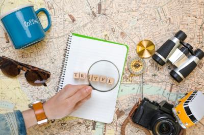 Magnifying Glass on Wooden Cubes Alongside Travel Elements – Free Download