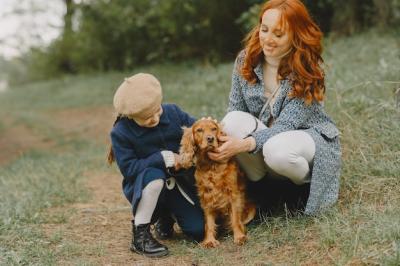 Mother and Daughter Enjoying Time with Their Dog in an Autumn Park – Free Download