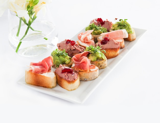 Bruschettas on a White Plate Illuminated by Light – Download Free Stock Photo