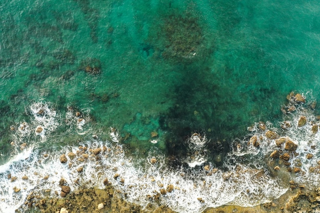 Aerial View of Sea Meeting Rocky Shore – Free Download