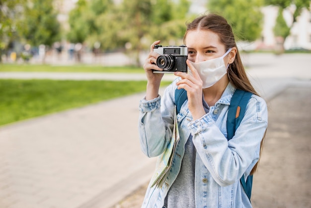 Traveller in a Medical Mask Capturing Moments – Free Download