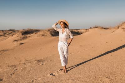 Beautiful Woman in White Outfit Walking in Desert Sand at Sunset – Free Download