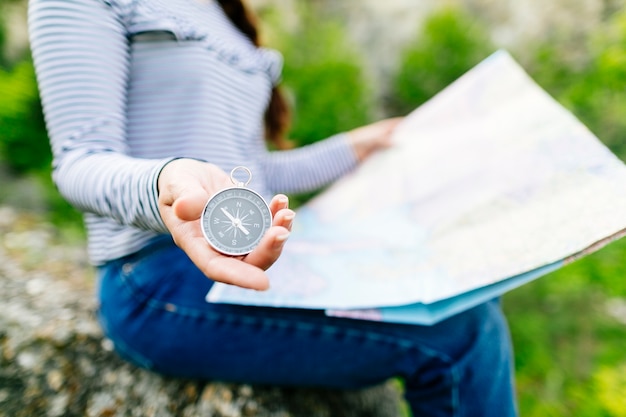 Woman Sitting on a Rock While Looking at a Map – Free Download