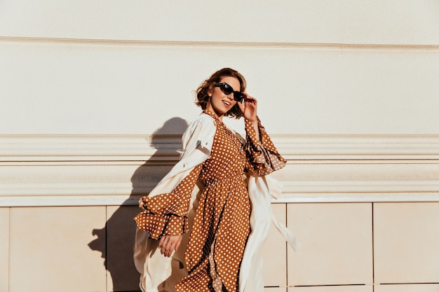 Pretty Woman in Long Brown Dress Enjoying a Sunny Day – Free Stock Photo for Download