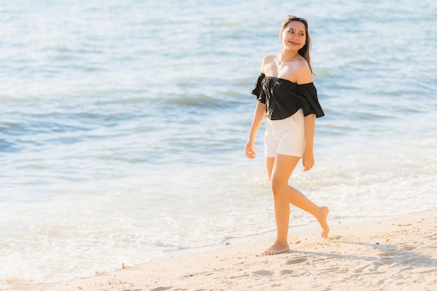 Beautiful Young Asian Woman Smiling at the Beach Sea – Free Download