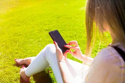 Woman Holding Smartphone Tenderly: Free Stock Photo for Download