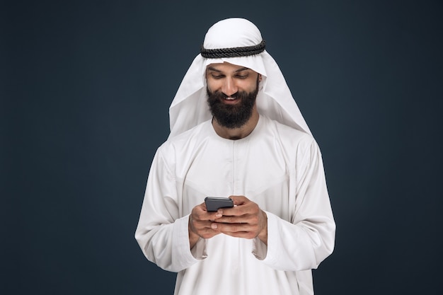 Half-Length Portrait of Arabian Saudi Man with Smartphone: Business and Technology Concept – Free Download