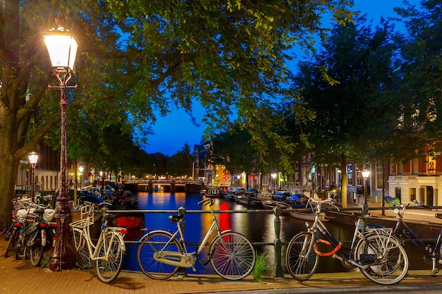 Night City View of Amsterdam Canal and Bridge, Boats and Bicycles in Holland, Netherlands – Free Stock Photo, Download for Free