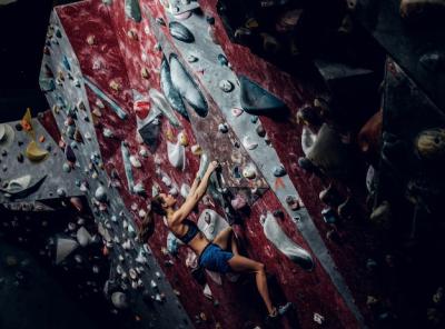 Professional Female Climber on a Bouldering Wall Indoors – Free Download