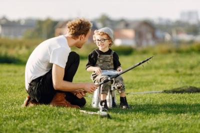 Quality Time Outdoors: Father and Curly Toddler Boy Enjoying Nature – Free Download