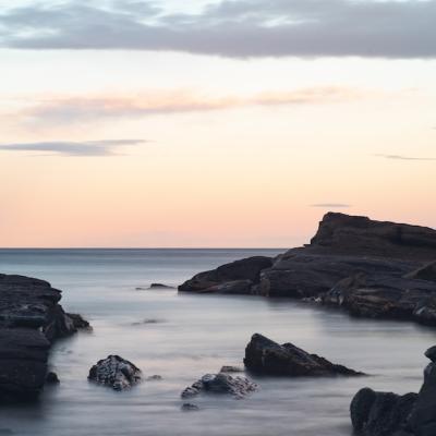 Stunning Rock Formations in the Sea Against a Colorful Sky – Free Download