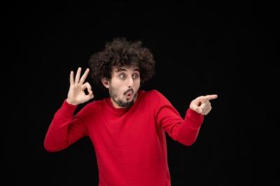 Young Male in Red Sweater Against Black Wall – Free Stock Photo, Download for Free