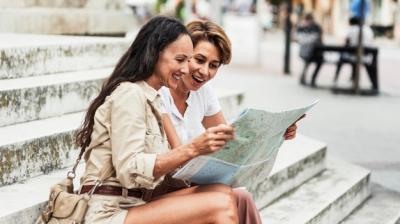 Smiley Women Exploring with Map – Free Download