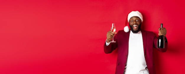 Handsome Black Man in Santa Hat Celebrating with Champagne – Free Stock Photo, Download for Free